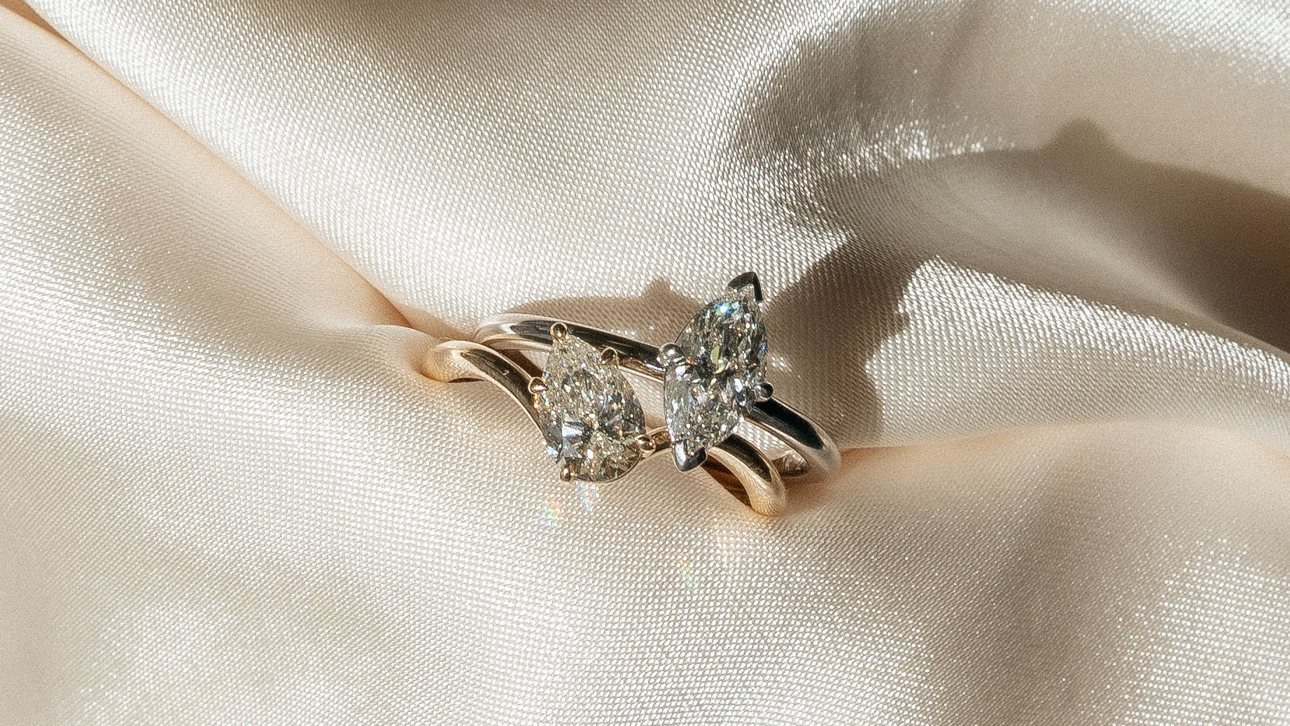 Diamond rings resting on ivory satin